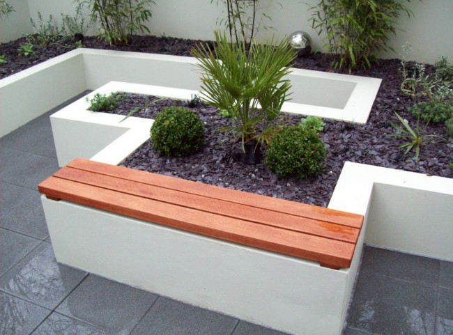 Seating area in a courtyard garden and raised borders