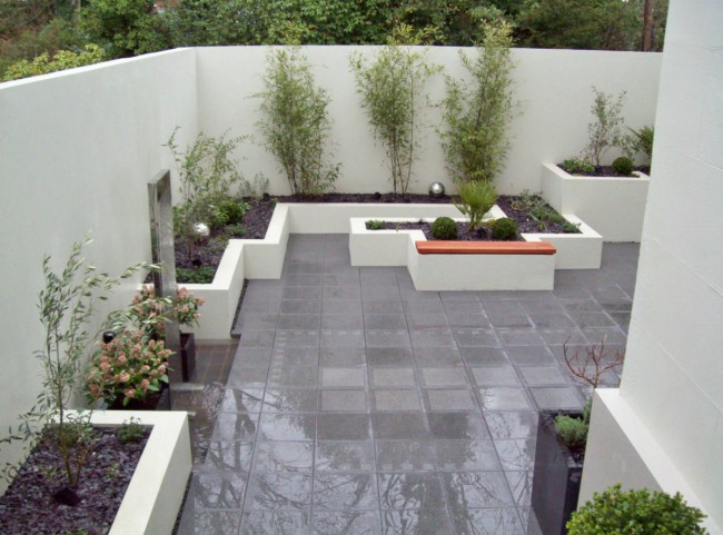 Walled courtyard garden with raised borders and rendered walls